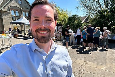 Adam Harley out in Bishopbriggs with people in the background.