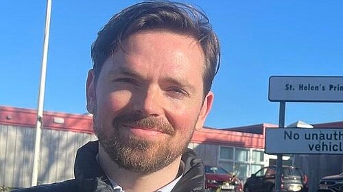 Adam Harley standing outside St Helen's primary school in Bishopbriggs