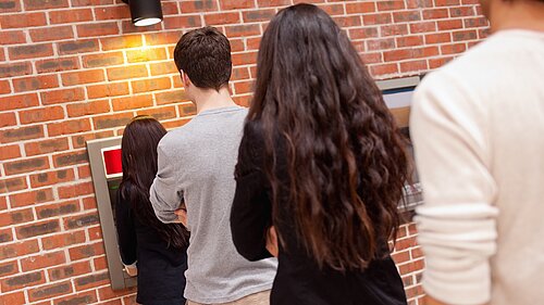 People queuing for an ATM.