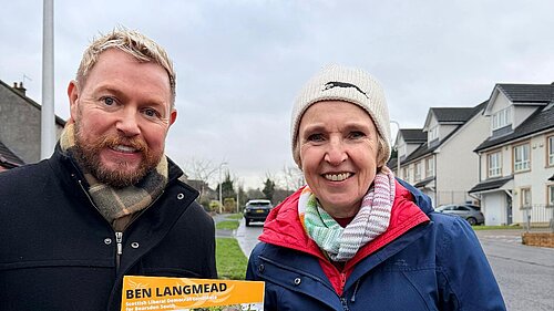 Jamie Greene and Susan Murray out campaigning holding canvass cards.
