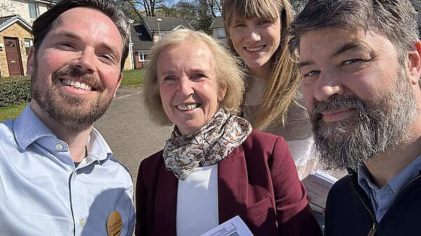 Adam Harley and Susan Murray out campaigning with volunteers.